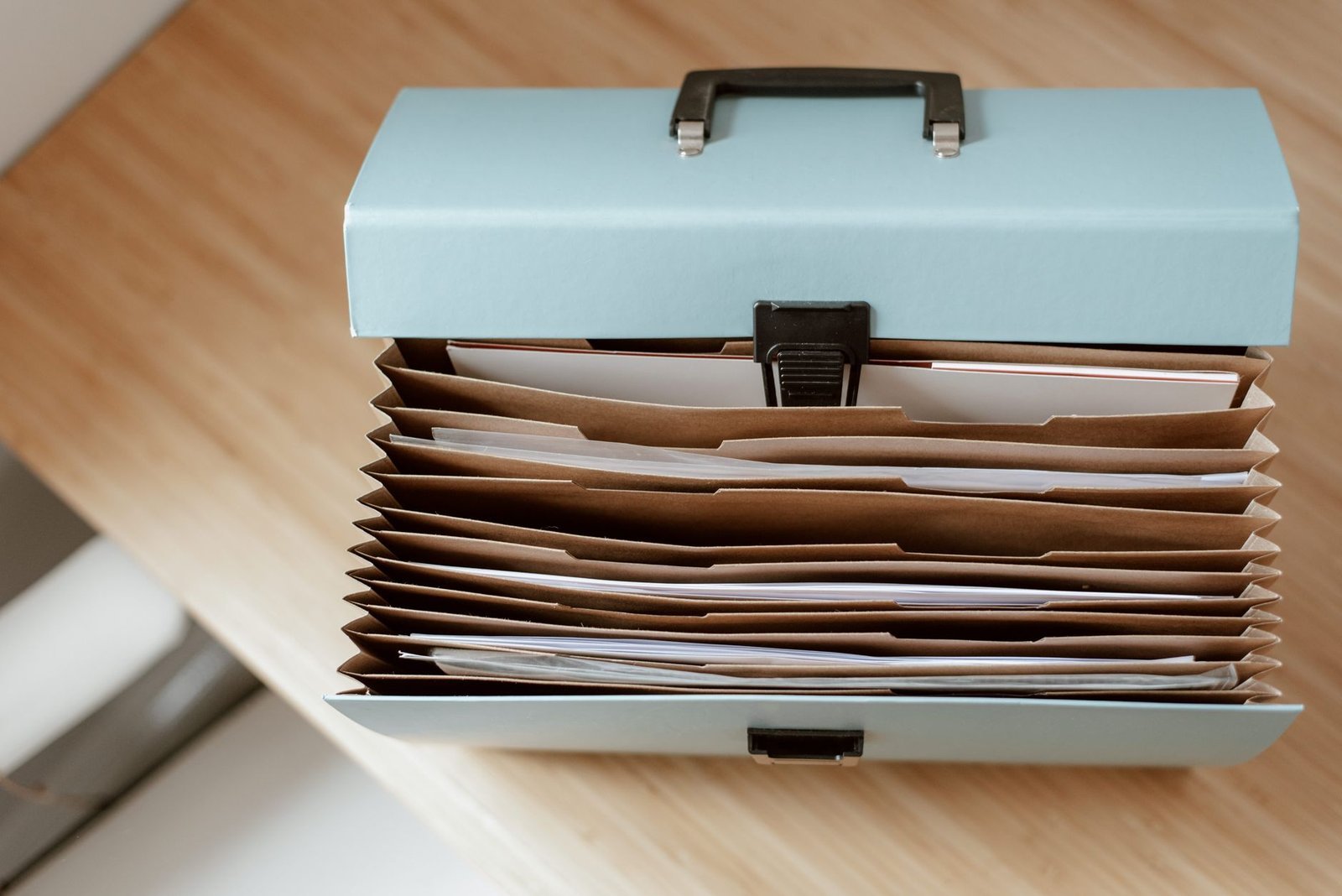 An open document case with its folders on a table